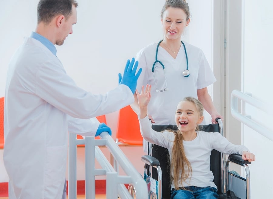 bigstock-child in wheelchair with doctor-173461787